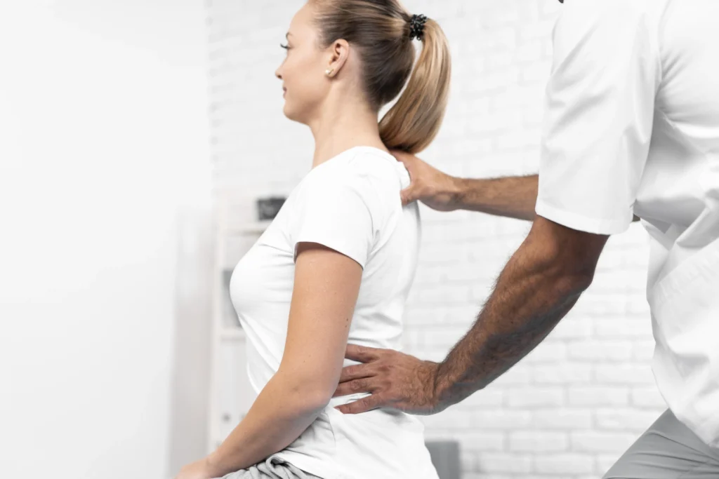 male physiotherapist checking woman s back (1)